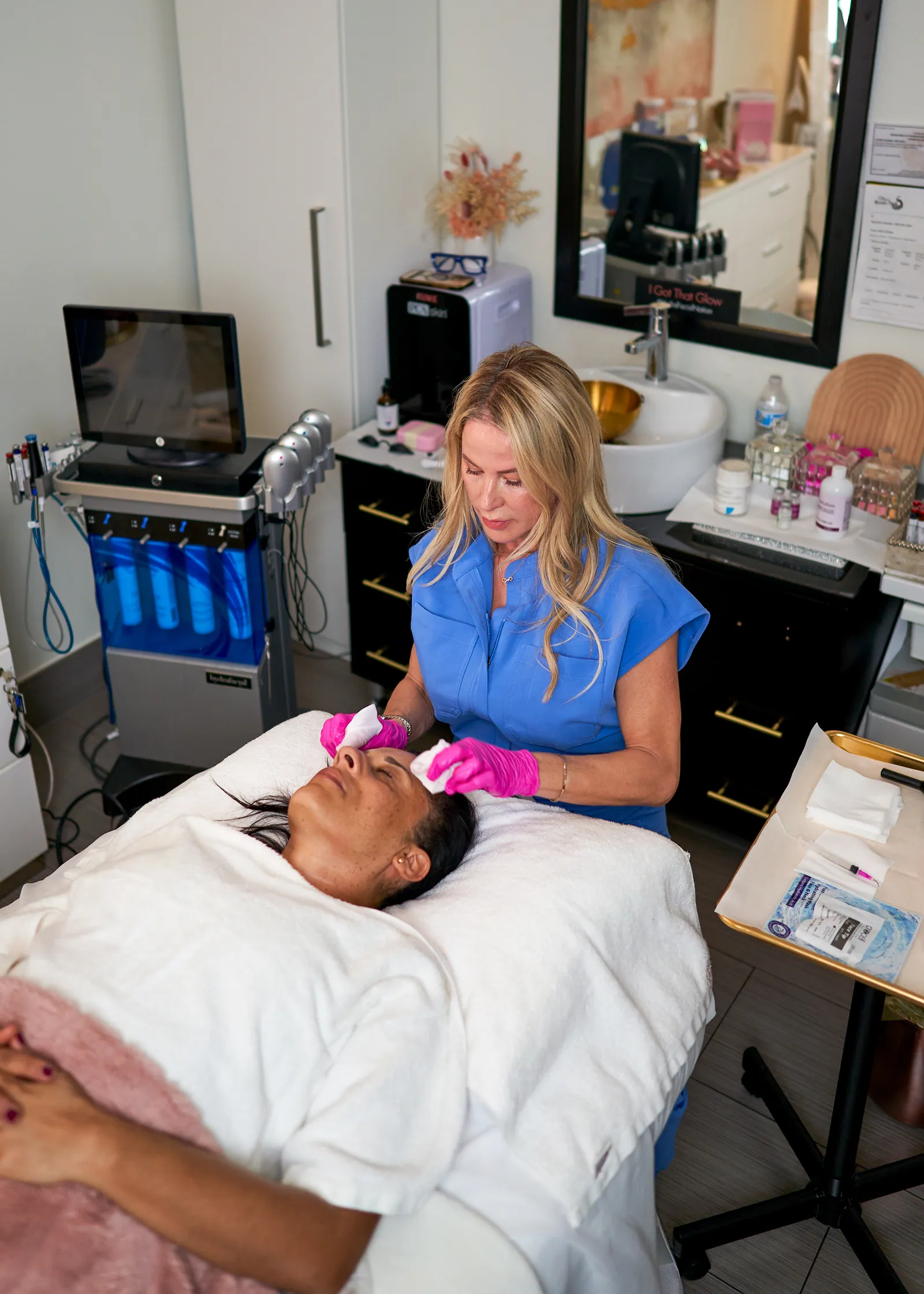 Loren treating a client during a facial in the Winter Park studio