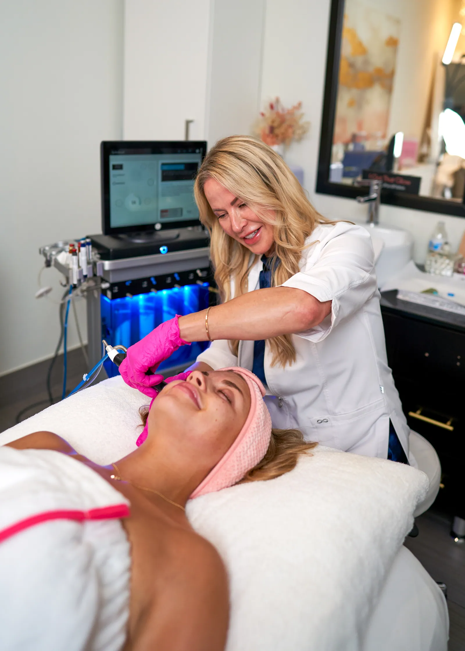 Loren treating a client during a corrective facial